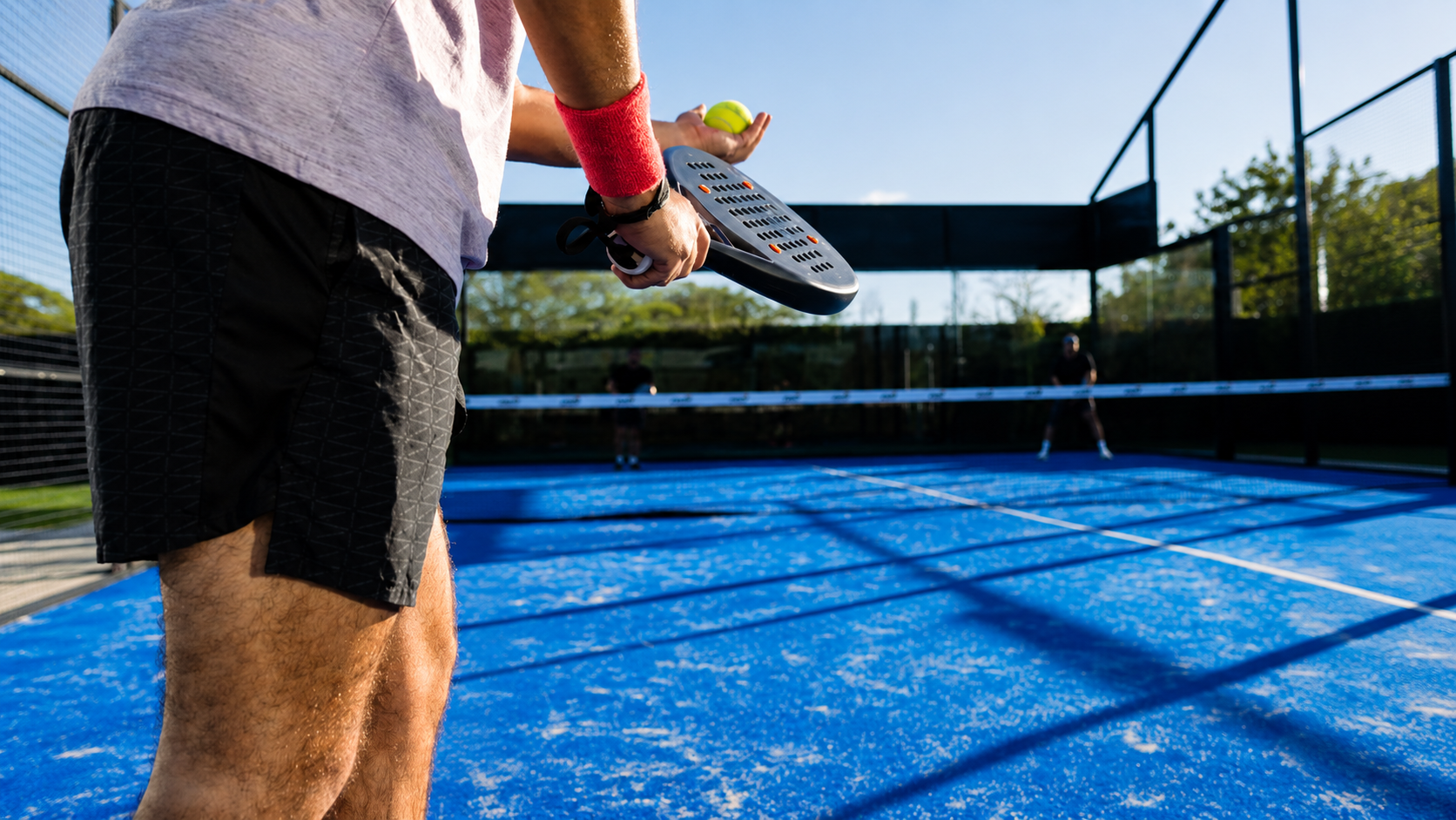 Player on a padel court in the sunshine
